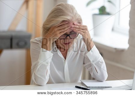 Aged Unhealthy Businesswoman Touch Forehead Suffers From Migraine