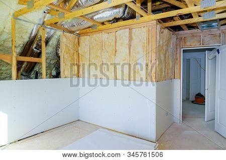 Installing Gypsum Plasterboard Sheet To Wall For Attic Room Construction At The Attic Polyurethane F