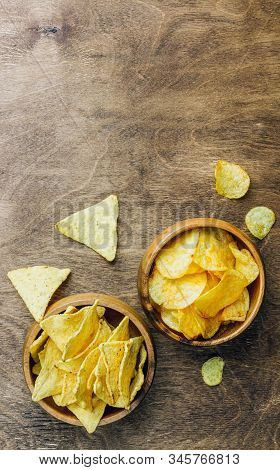 Table Fof Tasty Snacks And Beer Prepared For Watching Sports On Tv. Wooden Background. Top View. Fla
