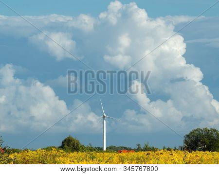 Wind Turbine Farm At The Field With Stormy Clouds. Wind Power For Electricity, Clean Energy. Baltic 