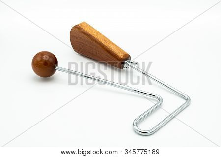 Closeup Of A Vibraslap Silver, Brown Wood On White Underground