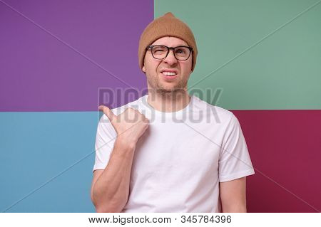 Man Wearing Glasses Points Finger Aside At Questionable Distrustful Announcement