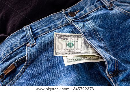 A Two Hundred Dollar Bills Inside Codpiece Of Blue Jeans Close-up With Selective Focus