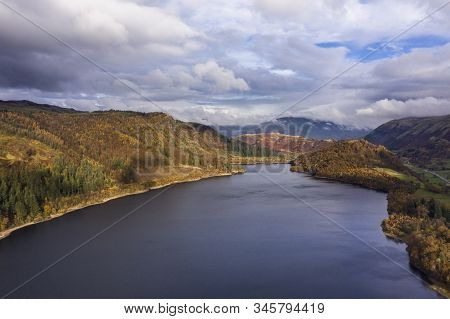 Beautiful aerial drone landscape image of glorious Autumn Fall sun over Thirlmere in Lake District
