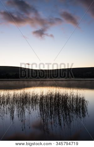 Epic Vibrant Sunrise Autumn Fall Landscape Image Of Ullswater In Lake District With Golden Sunlight