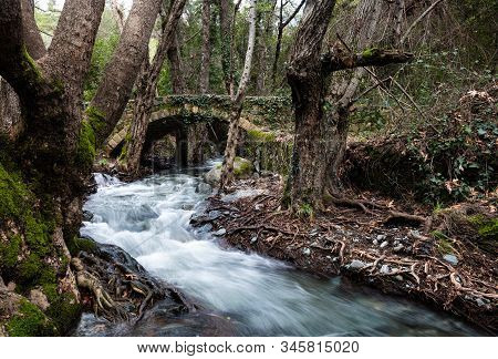 Beautiful Medieval Stoned  Bridge Or Milia With River Full With Water Flowing At Troodos Mountains I