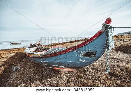 Wide-angle View Of An Old Wooden Fishing Boat On The Riverbank In Alcochete, Portugal: Flaked Multic