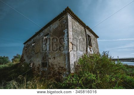 A Wide-angle View Of A Desolate Dilapidated Stone Building In A Small European District Alcochete, P