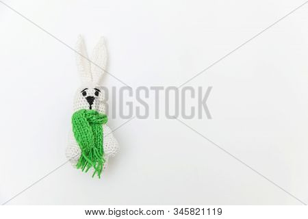 Simply Minimal Design With Toy Bunny In Green Scarf Isolated On White Background. Children Care Mate
