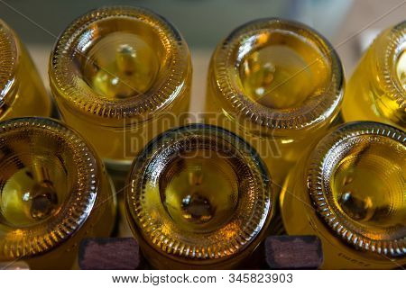 A Lot Of Amber Color Glass Empty Wine Bottles Bottom Close Up View, With A Punt At The Base, Winery 