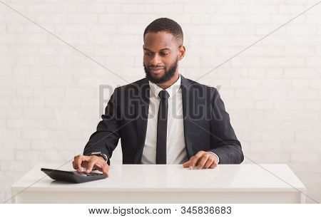 Business Financing, Accounting Consulting. African American Young Entrepreneur Sitting At Workdesk A