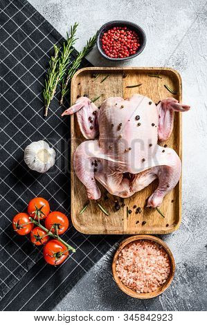 Concept Of Cooking Whole Poult. Ingredients Rosemary, Pink Salt, Garlic And Cherry Tomatoes. Gray Ba