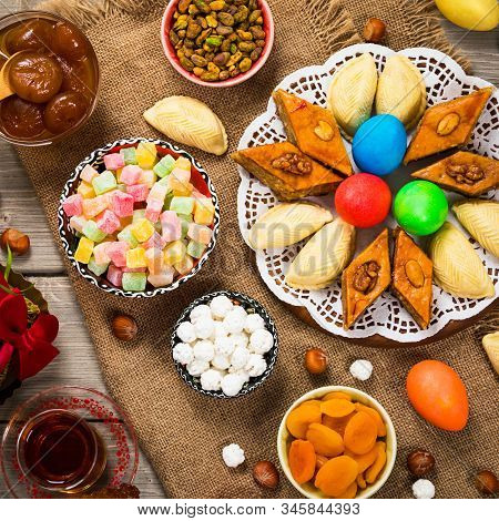 Novruz Ramadan In Azerbaijan. Colored Eggs, Wheat Springs For Easter And Traditional Sweets. Selecti