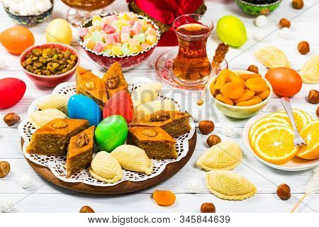 Novruz Ramadan In Azerbaijan. Colored Eggs, Wheat Springs For Easter And Traditional Sweets. Selecti
