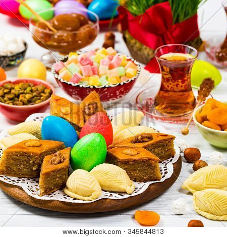 Novruz Ramadan In Azerbaijan. Colored Eggs, Wheat Springs For Easter And Traditional Sweets. Selecti