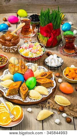 Novruz Ramadan In Azerbaijan. Colored Eggs, Wheat Springs For Easter And Traditional Sweets. Selecti