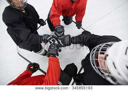 Above View Background Of Hockey Team Huddling Ready To Start Match On Skating Rink, Copy Space