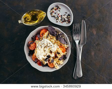 Tasty Italian Fusilli Pasta With Cherry, Mozarella Or Buratta Cheese And Fresh Basil. Dish With Past