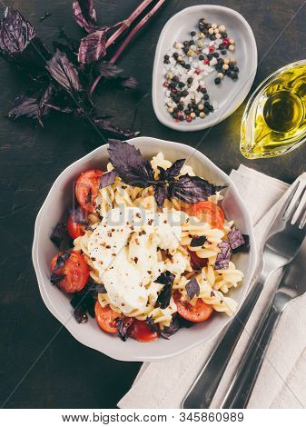 Tasty Italian Fusilli Pasta With Cherry, Mozarella Or Buratta Cheese And Fresh Basil. Dish With Past