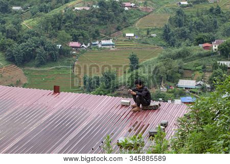 Sapa, Vietnam- June 13, 2019: Sapa City, Central Streets Of The City, The Boy Sits On The Roof Of Th
