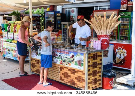 Antalya, Turkey - July 26, 2019: Ice Cream Seller In Turkey In Antalya Puts Ice Cream To A Boy And A