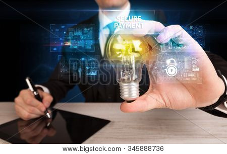 Businessman holding lightbulb with SECURE PAYMENT inscription, online security idea concept