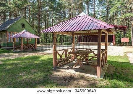 Wooden Camping Arbors  With All Conviniences In A Pine Forest