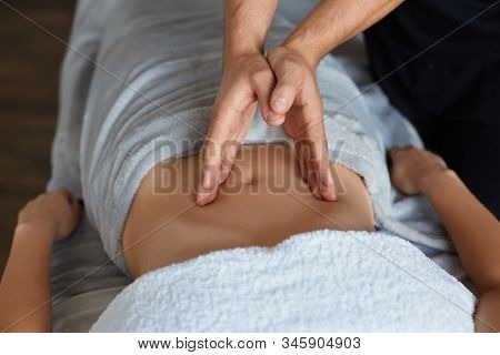 Young Beautiful Woman Enjoying Anticellulite Belly Massage In Spa.professional Massage Therapist Is 