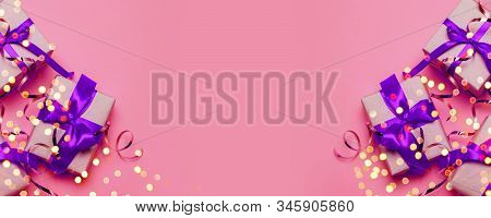 Flat Lay Composition Of Bright Surprise Or Gift Box Wrapped In Craftpaper And Silk Ribbon Bow On A P