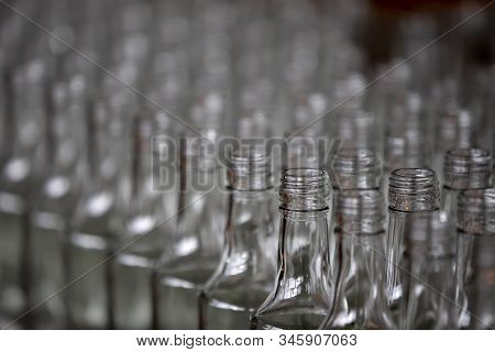 Glassworks. Glass Industry. Many Glass Bottles On A Factory Conveyor.