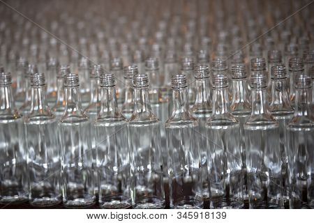 Glassworks. Glass Industry. Many Glass Bottles On A Factory Conveyor.