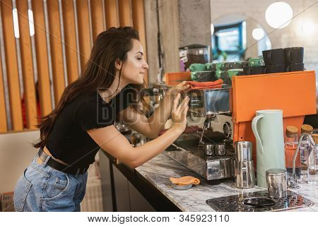 Young Barista Woman Cleaning Professional Coffee Machine With Dust , Barist Work Routine