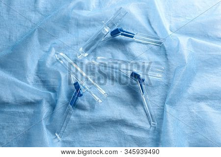 Anoscopes On Light Blue Fabric, Flat Lay. Hemorrhoid Treatment