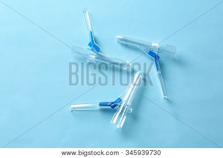 Anoscopes On Light Blue Background, Flat Lay. Hemorrhoid Treatment