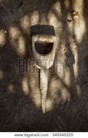 Old Fashioned Wooden Gardening Dibber Tool, Shot From Above On A Dirty Shed Floor