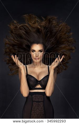 Sexy Brunette Woman With Wind On Hiar
