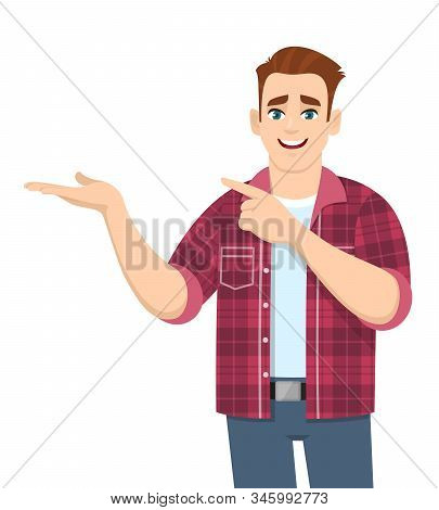 Handsome Stylish Young Man Showing Hand And Pointing Finger To Copy Space. Smiling Person In Casual 