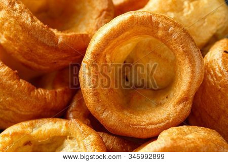 Traditional English Yorkshire Pudding Side Dish On Black Plate And Background