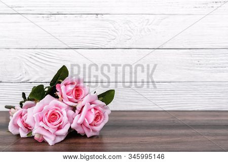 Pink Roses On Top Of Wooden Table With Copy Space - Valentine's Day Concept