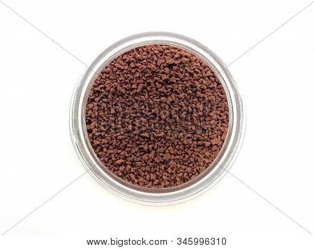 Top View Of Instant Coffee In A Glass Bottle On White Background