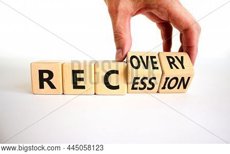 Recovery And Recession Symbol. Businessman Turns Cubes And Changes The Word 'recession' To 'recovery
