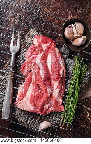 Ready For Cooking On Grill Boneless Lamb Meat, Raw Neck Meat With Herbs. Dark Background. Top View