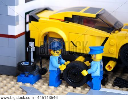 Tambov, Russian Federation - January 03, 2022 Two Lego Mechanics Minifigures Changing A Wheel On A L
