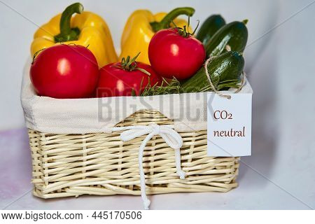 Wicker Basket With Carbon Neutral Product Label On Fresh Vegetables. Carbon Labeling. Net Zero Carbo