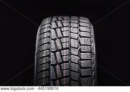Winter Tire New Friction Velcro For Safe Driving In Icy Conditions On A Black Background Front View