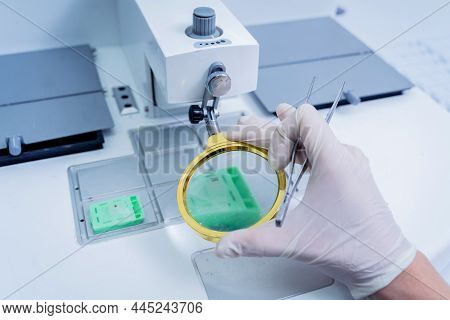Laboratory Assistant Works At Paraffin Wax Dispenser Tissue Embedding Machine.