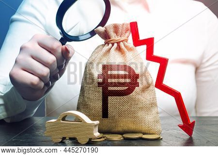 Female Surveyor Examines A Israeli Shekel Money Bag With A Red Down Arrow And Auto. Ice. Fuel Excise