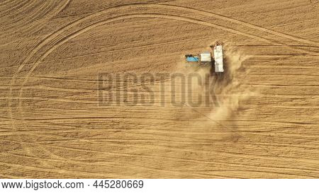 4k Aerial View Tractor With Seed Drill Machine Sowing Seeds For Crops In Spring Season. Beginning Of