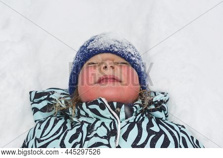 Caucasian Child In Winter Clothing Playing Outdoors