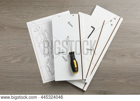 Flat Lay Composition With Furniture Parts And Tools For Self-assembly On Wooden Background